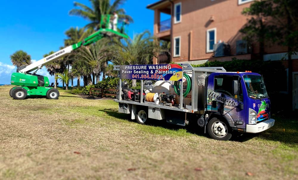 Ultimate Services pressure washing truck and lift on a job