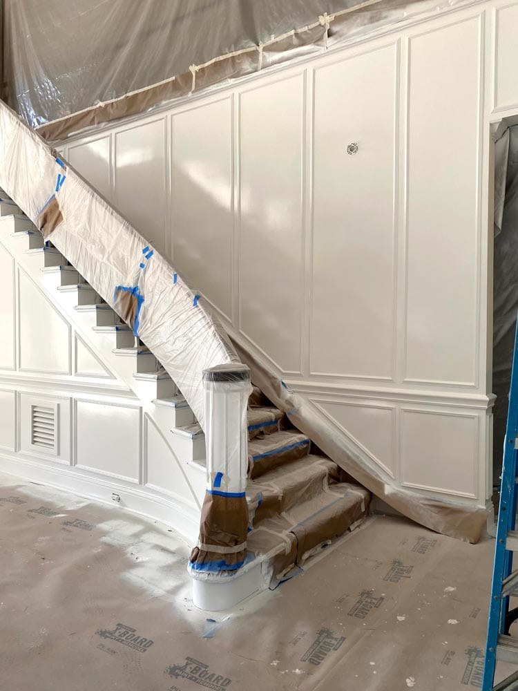 Staircase and wainscoting being prepped and painted