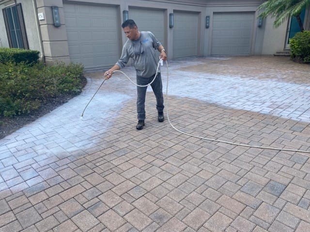 Applying sealer to a paver driveway, from the Ultimate Services website